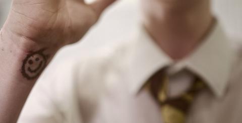 Boy with tattoo on wrist