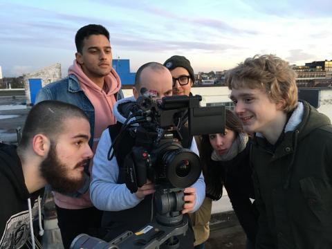 Young people from Beatfreeks gathered around a camera